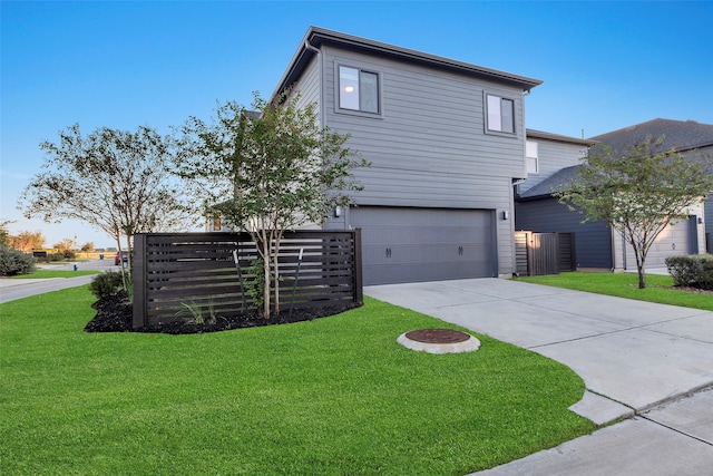 view of front of house featuring a garage and a front lawn