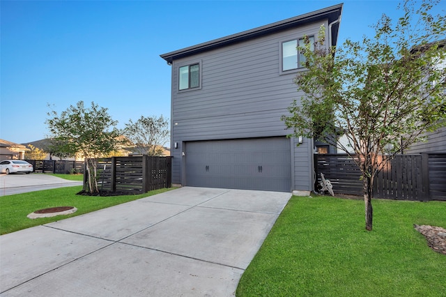 view of side of home featuring a lawn and a garage