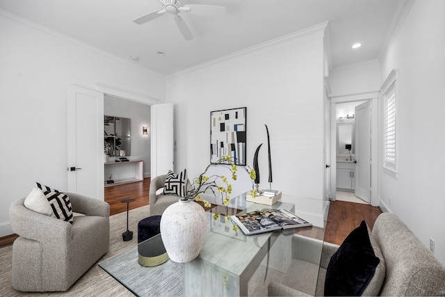 living room with wood-type flooring, ceiling fan, and crown molding