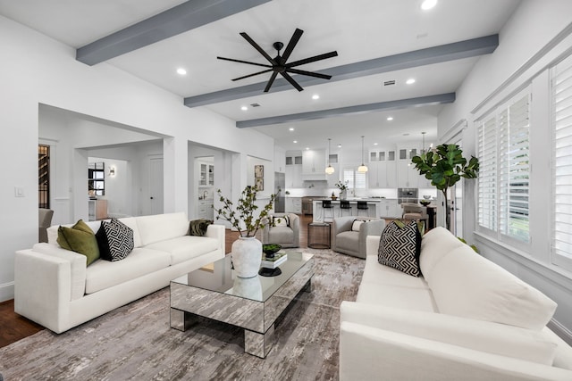 living room featuring a ceiling fan, recessed lighting, beamed ceiling, and wood finished floors