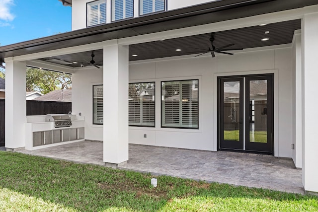 view of patio / terrace with an outdoor kitchen, a grill, ceiling fan, and french doors