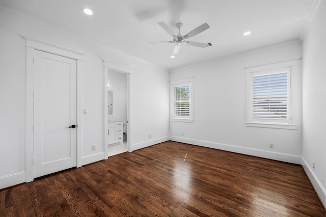 unfurnished bedroom featuring ensuite bathroom, ceiling fan, dark hardwood / wood-style floors, and crown molding