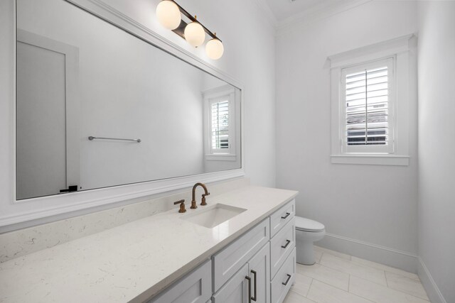 bathroom with tile patterned flooring, vanity, toilet, and ornamental molding