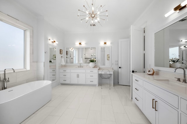 bathroom with vanity, crown molding, a bathing tub, and plenty of natural light