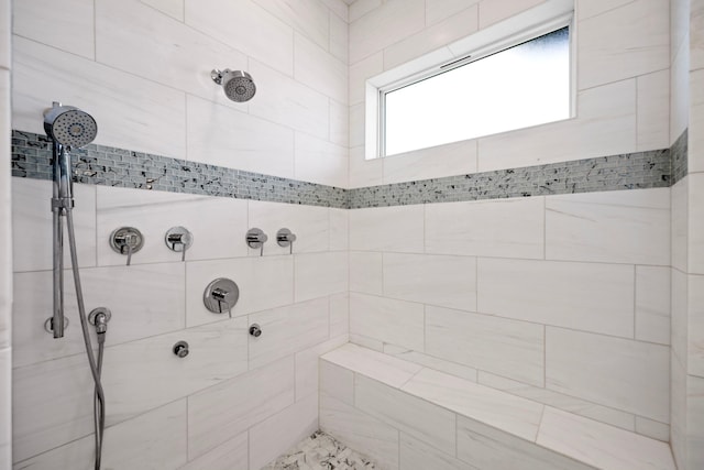 full bath with a tile shower