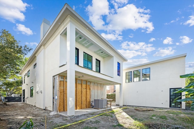 back of property featuring central AC unit