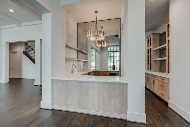 kitchen featuring hanging light fixtures, light brown cabinets, and dark wood-type flooring