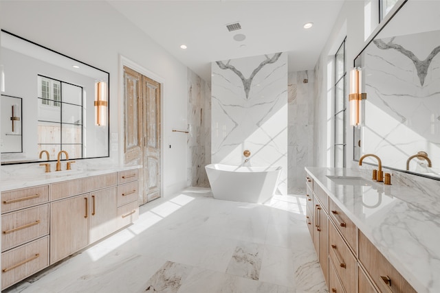 bathroom with a bathing tub and vanity