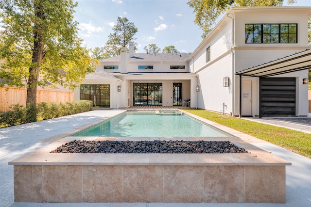 view of pool with a patio and an outdoor fire pit