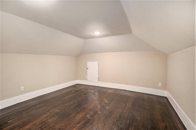 bonus room featuring wood-type flooring and vaulted ceiling