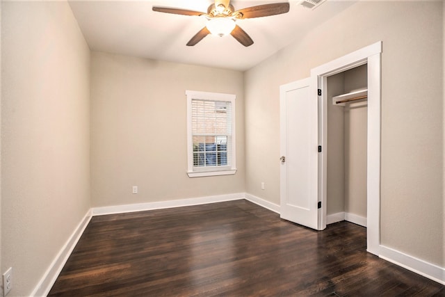 unfurnished bedroom with ceiling fan, a closet, and dark hardwood / wood-style floors