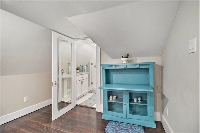 bathroom featuring sink, lofted ceiling, and hardwood / wood-style flooring