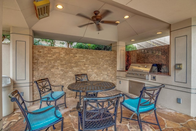 view of patio featuring ceiling fan, area for grilling, and a grill