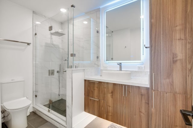 bathroom with toilet, vanity, tile patterned floors, and walk in shower