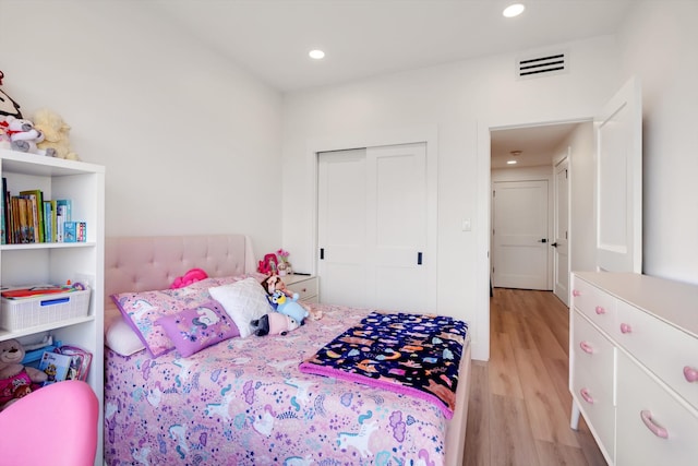 bedroom featuring a closet and light hardwood / wood-style flooring