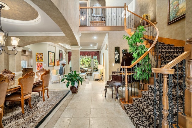 interior space with decorative columns, crown molding, and beamed ceiling