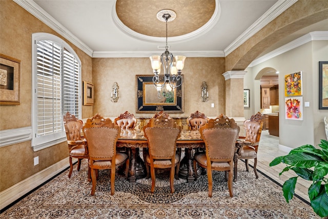 dining area with ornamental molding, decorative columns, and a notable chandelier