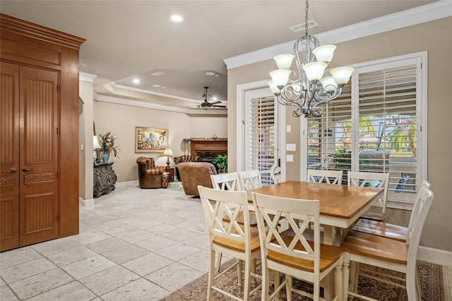 dining space with ceiling fan with notable chandelier and crown molding