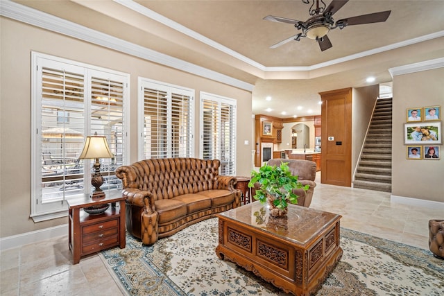 living room with ceiling fan and crown molding