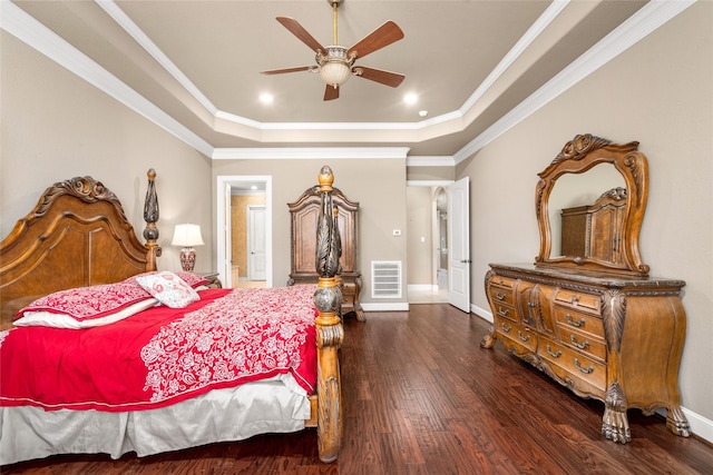 bedroom with dark wood-type flooring, a raised ceiling, ceiling fan, and crown molding