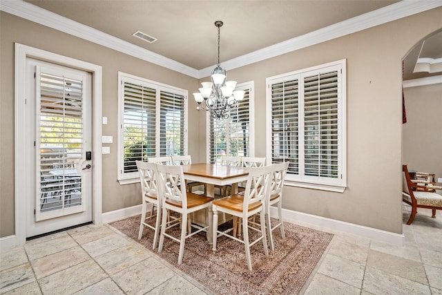 dining space with an inviting chandelier and ornamental molding