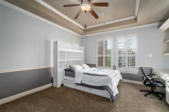 bedroom with carpet, ceiling fan, crown molding, and a tray ceiling