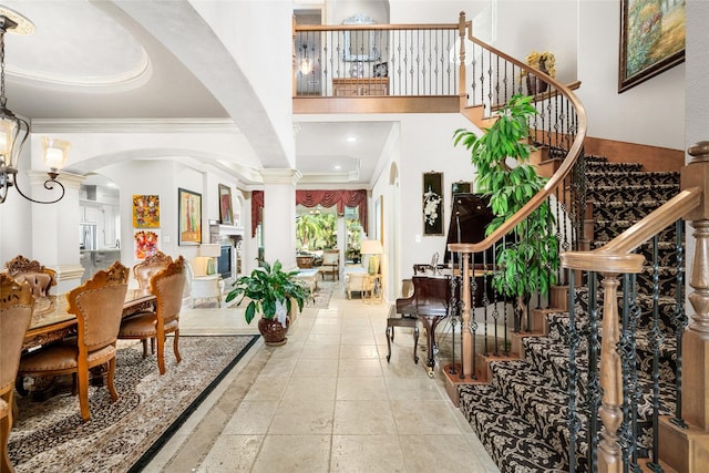 foyer entrance with beam ceiling and crown molding