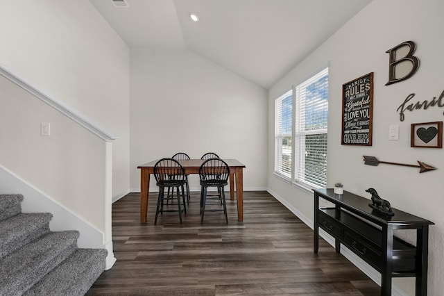 dining room featuring dark hardwood / wood-style flooring and vaulted ceiling