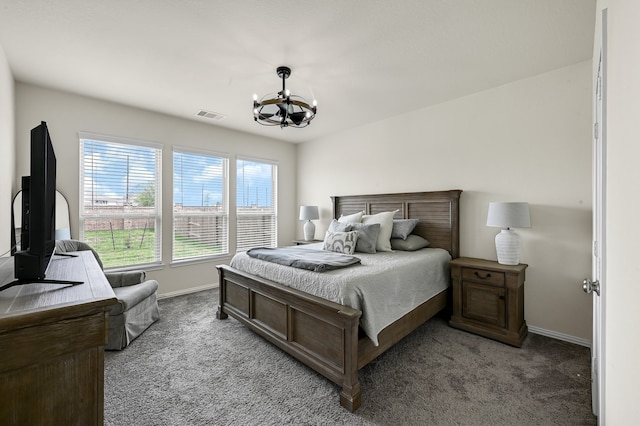 carpeted bedroom with a chandelier