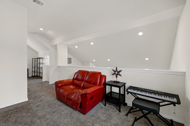 sitting room with lofted ceiling and carpet flooring