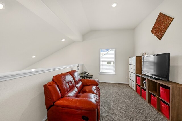 living area featuring lofted ceiling and carpet floors