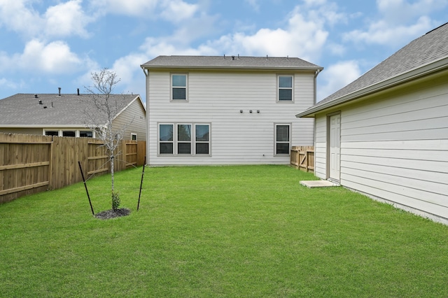 back of house featuring a yard