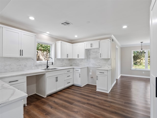 kitchen featuring white cabinets, a wealth of natural light, sink, dark hardwood / wood-style floors, and pendant lighting