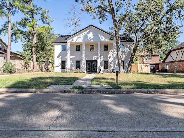 neoclassical / greek revival house featuring a front lawn