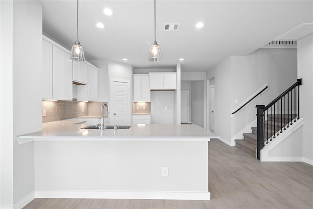 373 Spruce Oak Ln, Waller, TX 77484 - kitchen featuring a sink, a peninsula, recessed lighting, white cabinets, and light countertops
