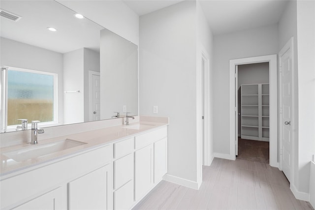 373 Spruce Oak Ln, Waller, TX 77484 - full bathroom with double vanity, recessed lighting, a spacious closet, and baseboards