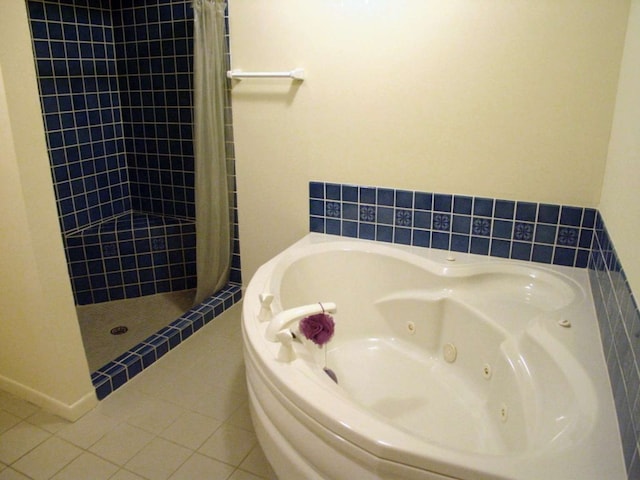 bathroom featuring tile patterned flooring and shower with separate bathtub