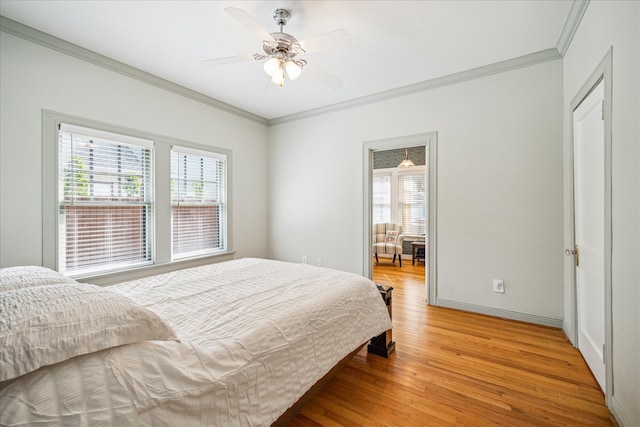 bedroom featuring hardwood / wood-style floors, ceiling fan, and crown molding