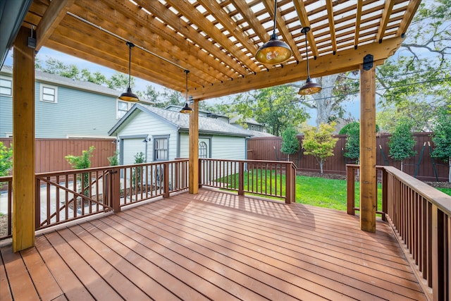 wooden terrace featuring a garage, a pergola, a yard, and an outdoor structure