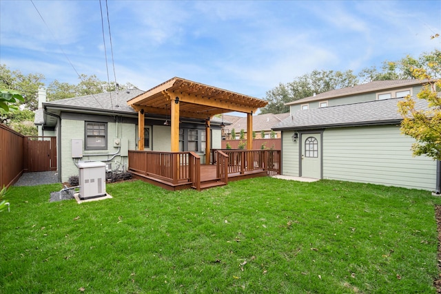 rear view of house with a deck, central AC, a yard, and a pergola