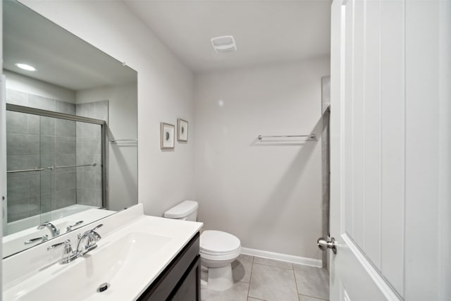 bathroom featuring toilet, vanity, an enclosed shower, and tile patterned floors