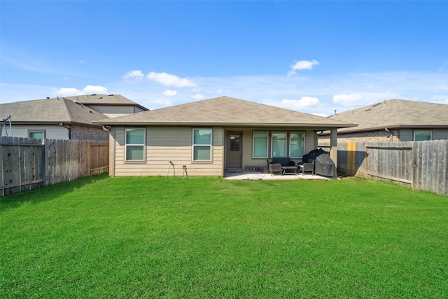 rear view of house with a yard and a patio area