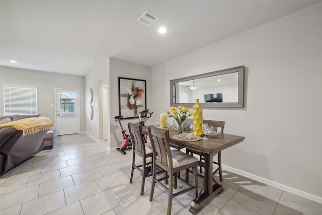 tiled dining area with ceiling fan