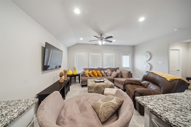 living room featuring lofted ceiling, light tile patterned floors, and ceiling fan