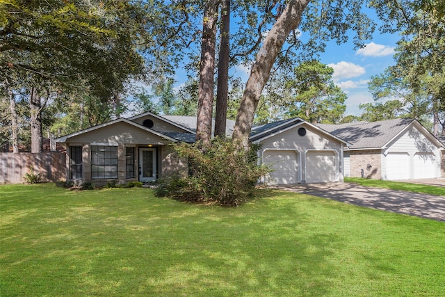 ranch-style home featuring a front lawn and a garage