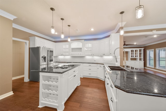 kitchen with dark wood-type flooring, white cabinets, sink, a kitchen island, and decorative light fixtures