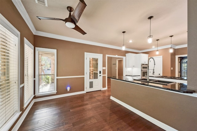 kitchen with ornamental molding, white cabinetry, pendant lighting, dark wood-type flooring, and ceiling fan