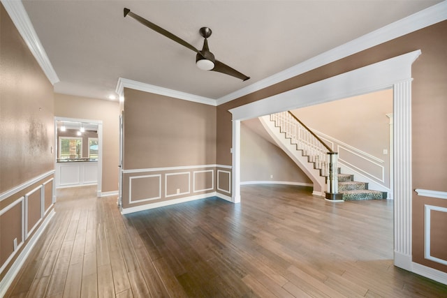 unfurnished living room featuring ceiling fan, hardwood / wood-style flooring, and ornamental molding