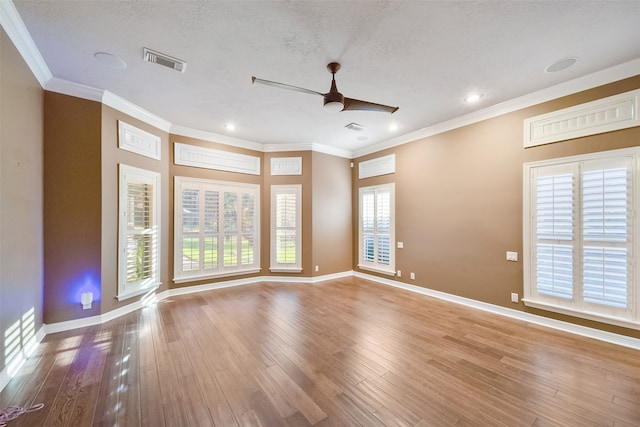 unfurnished room with a textured ceiling, crown molding, ceiling fan, and light hardwood / wood-style flooring