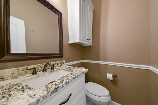 bathroom with toilet and vanity